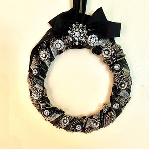 Detailed black round filled with gems and beading